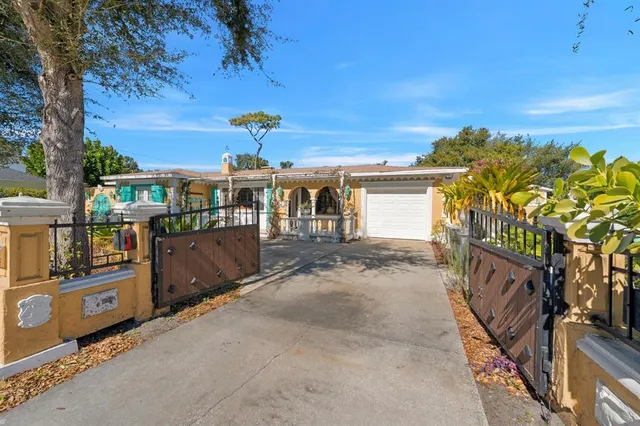 a view of a patio with chairs and potted plants