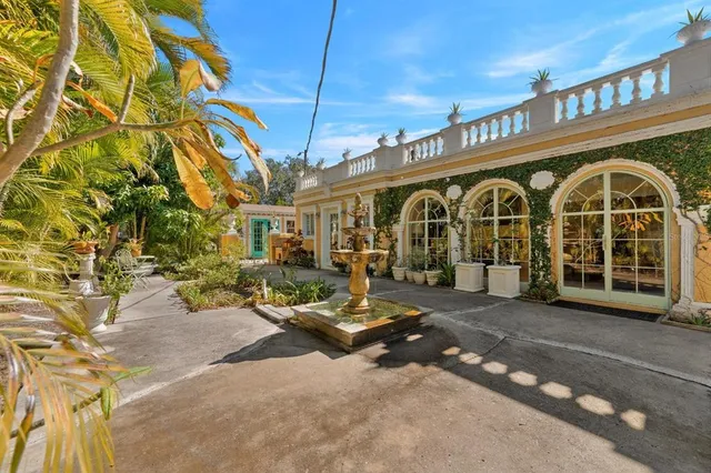 a living room with furniture a wooden floor and a large window