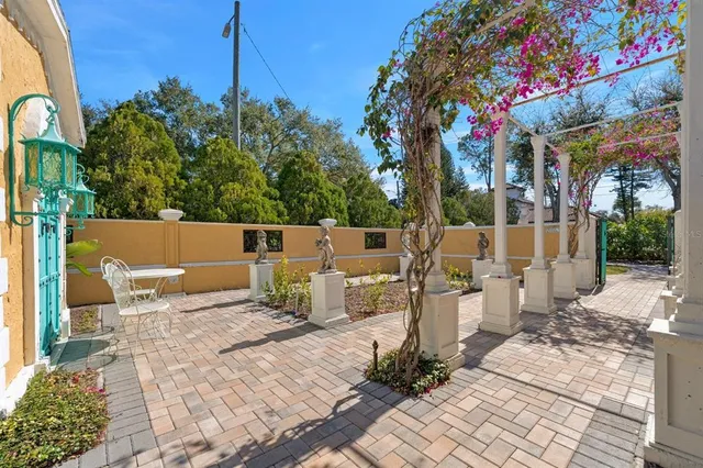 an aerial view of a house with a yard and lake view