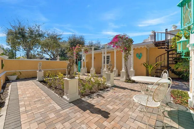 an aerial view of a house with a yard and lake view
