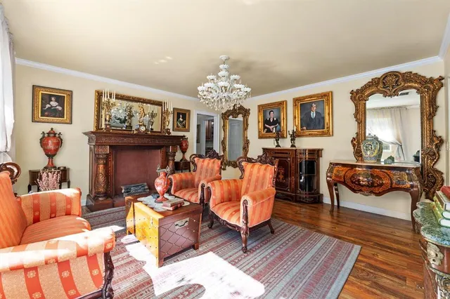 a view of a dining room with furniture and chandelier