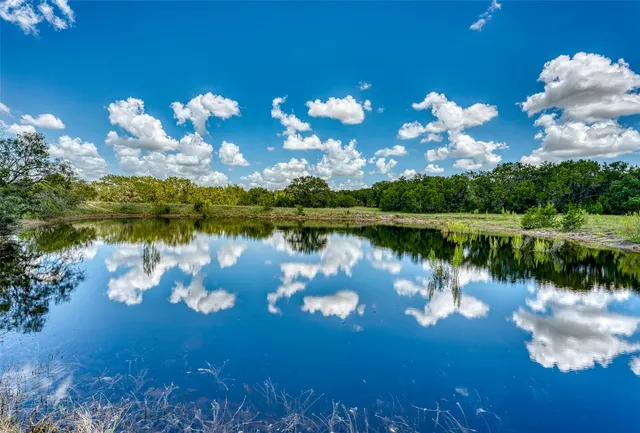 a view of a lake with swimming pool and middle of the house