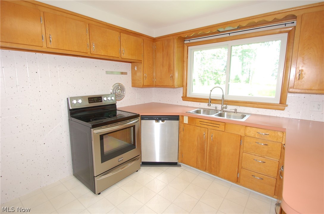 1299 State Road Vermilion, OH 44089 - Photo 17 of 36 Kitchen with sink, appliances with stainless steel finishes, and light tile patterned floors