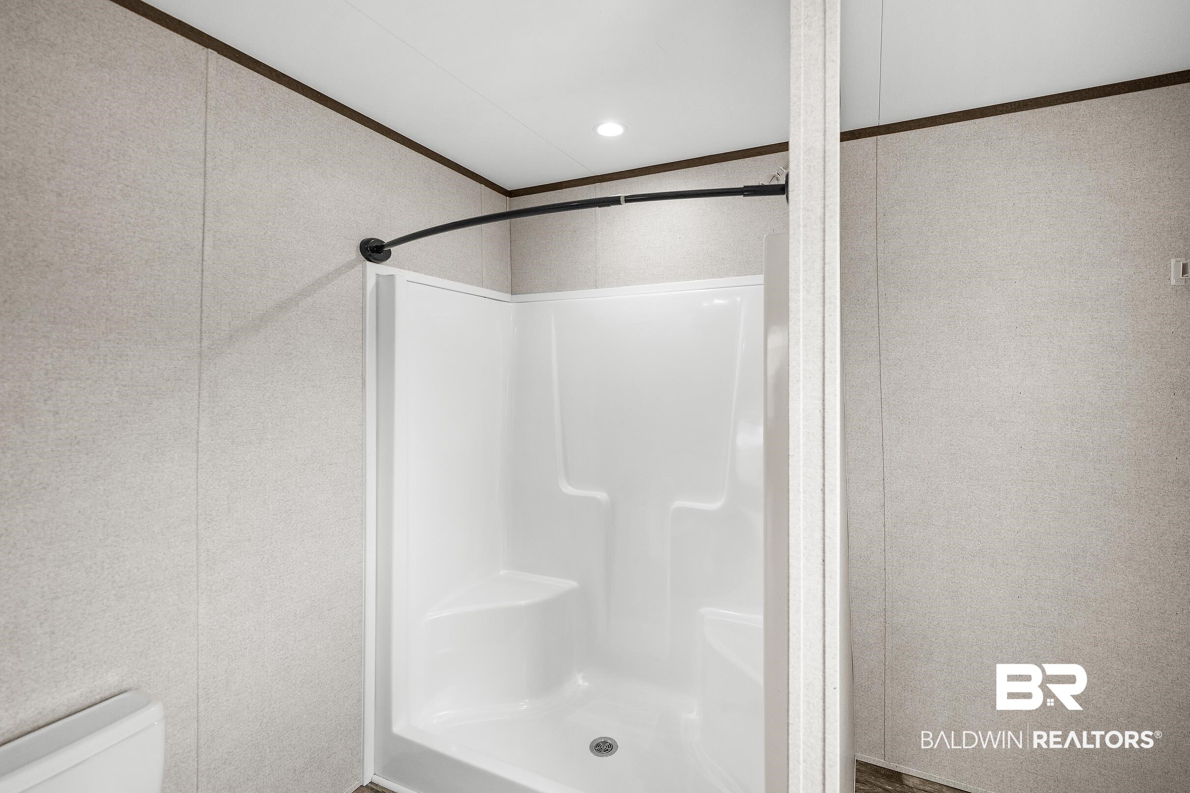 21601 Westside Loop Silverhill, AL 36576 - Photo 26 of 42 White fiberglass shower enclosure with a built-in seat and integrated shelving