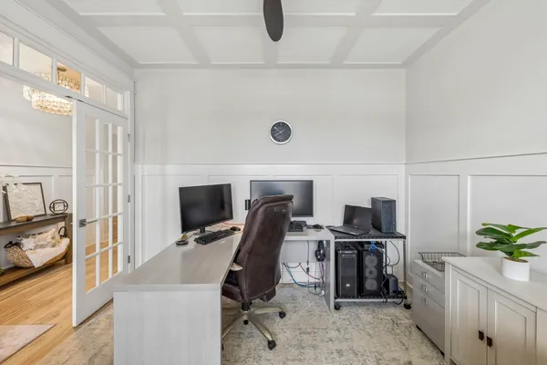 a view of a hallway with wooden floor and staircase