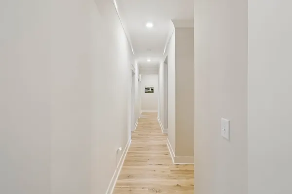 a living room with furniture and a view of kitchen
