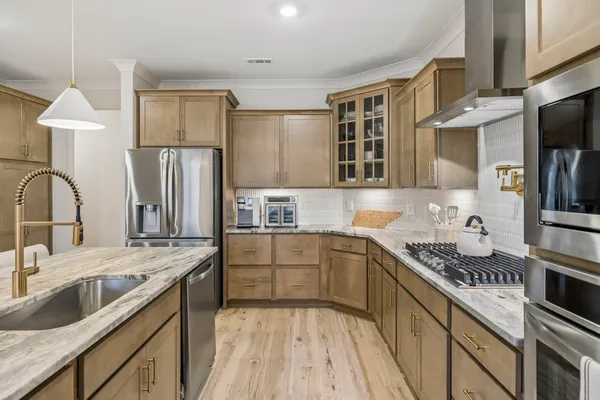 a kitchen with a table chairs sink and cabinets