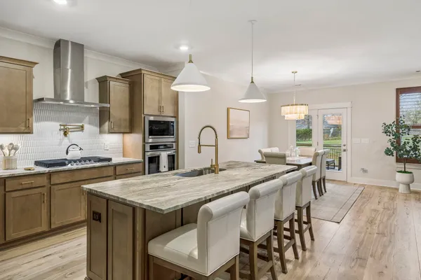 a bathroom with a granite countertop shower a mirror and a sink