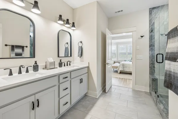 a bedroom with a bed and a lamp