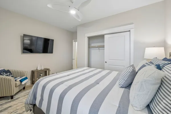 a view of a hallway with wooden floor and a living room