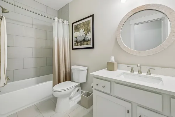 an aerial view of residential houses with outdoor space and parking