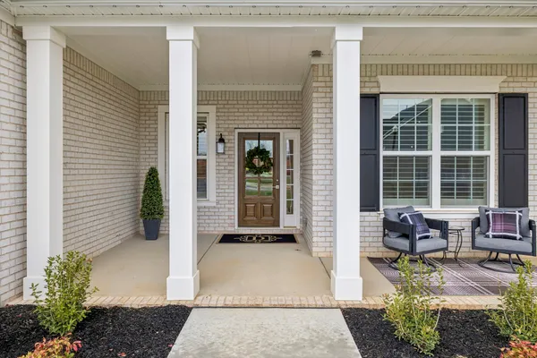 a view of an entryway with wooden floor