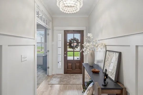 a living room with furniture a flat screen tv and a window