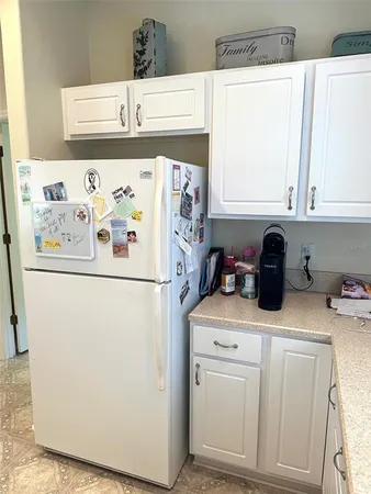 a white refrigerator freezer sitting inside of a kitchen