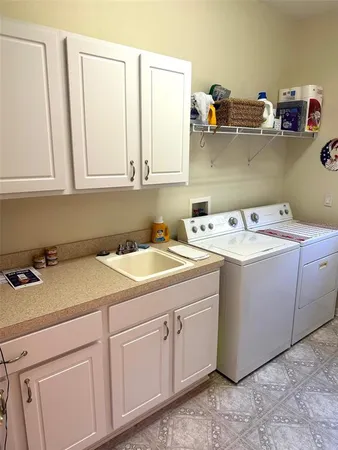 a utility room with a sink washer and dryer
