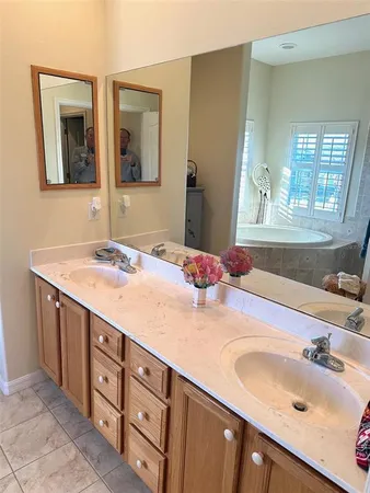 a bathroom with a double vanity sink and a mirror