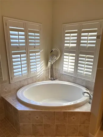 a bath tub sitting in a bathroom next to a window