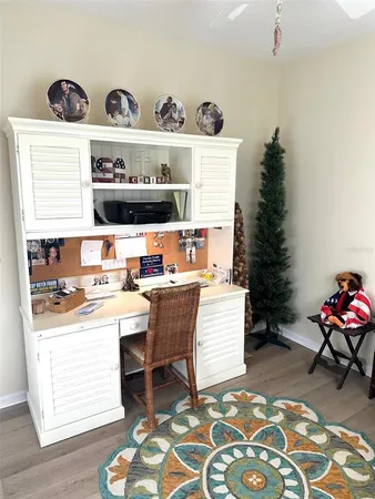 a room with a workspace and a wooden floor