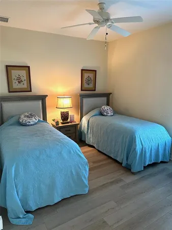 a bedroom with two beds and painting on the wall