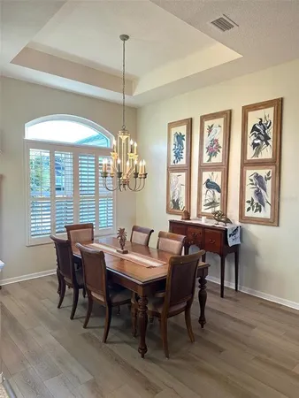 a view of a dining room with furniture wooden floor and chandelier