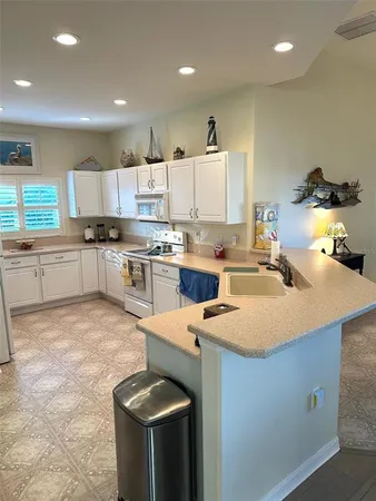 a kitchen with a stove a sink and a refrigerator