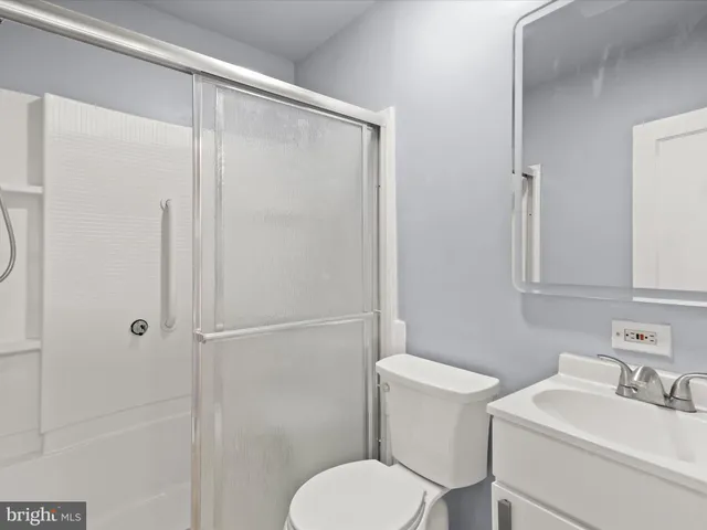 a white toilet sitting next to a bathroom sink