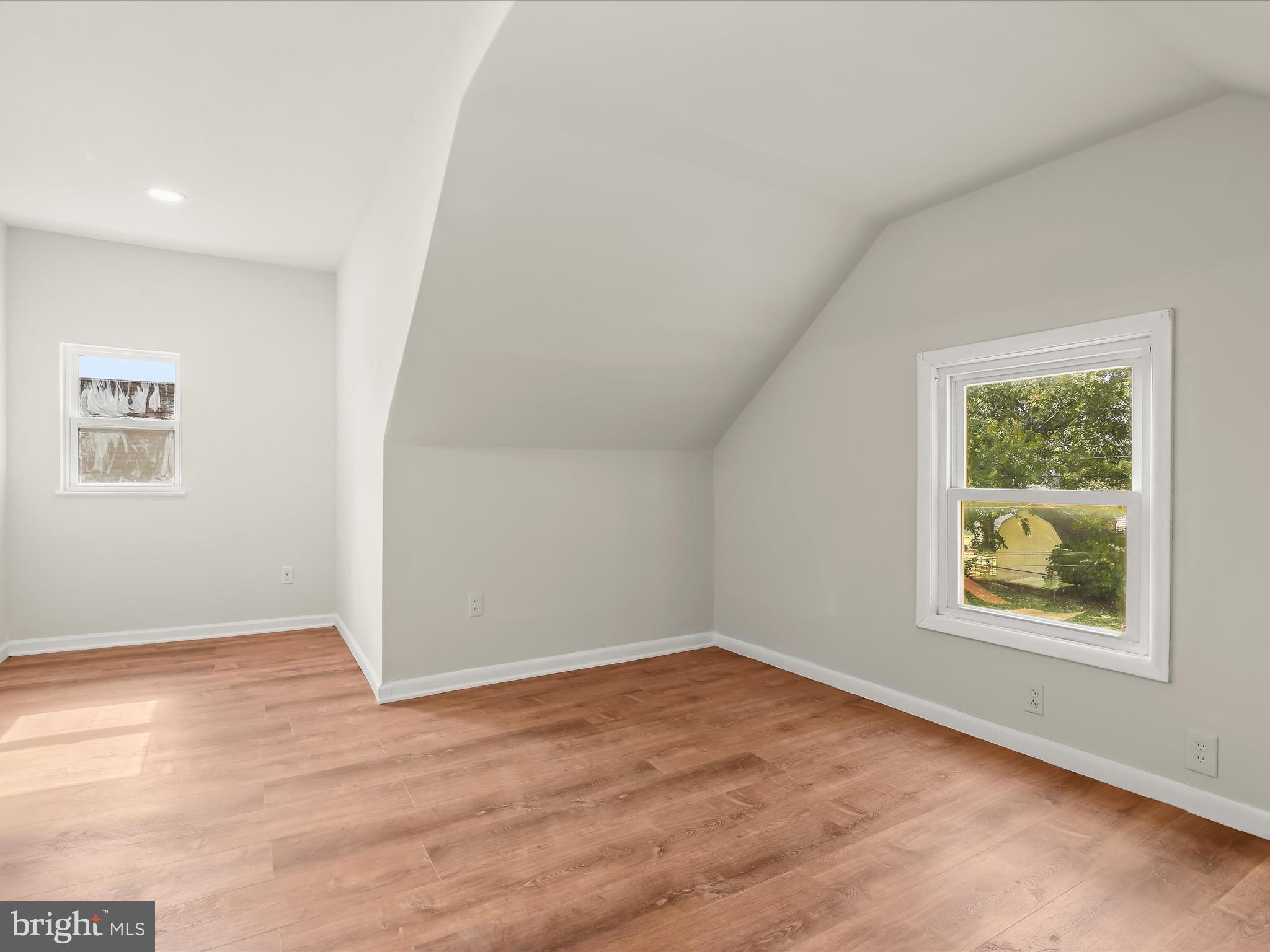 2608 Ambler Road Dundalk, MD 21222 - Photo 19 of 34 an empty room with a wooden floor and window