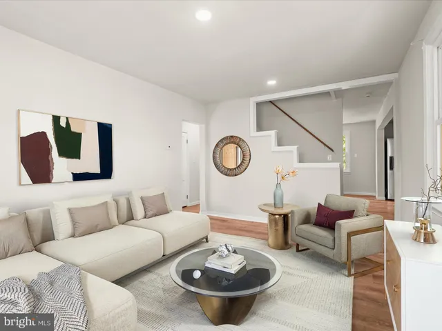 a living room with furniture a rug and a table