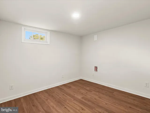 a view of a room with wooden floor and white walls