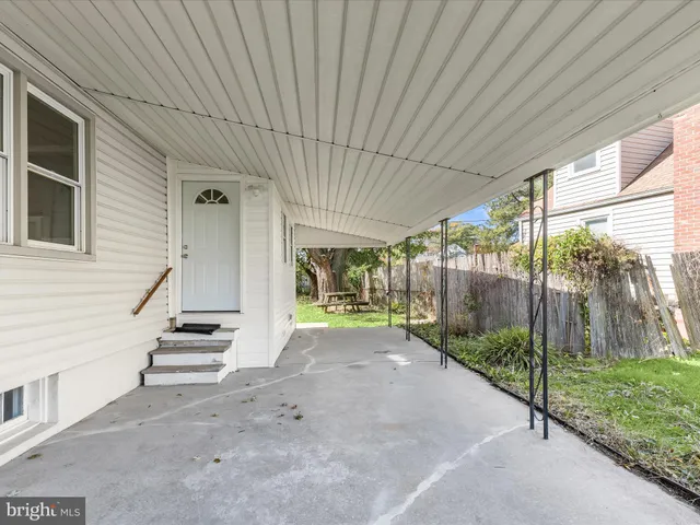 a view of a house with backyard and wooden fence