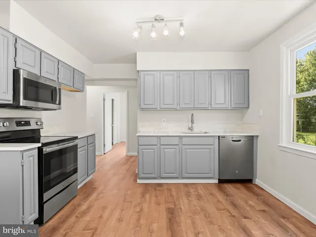 a kitchen with a sink stove and microwave