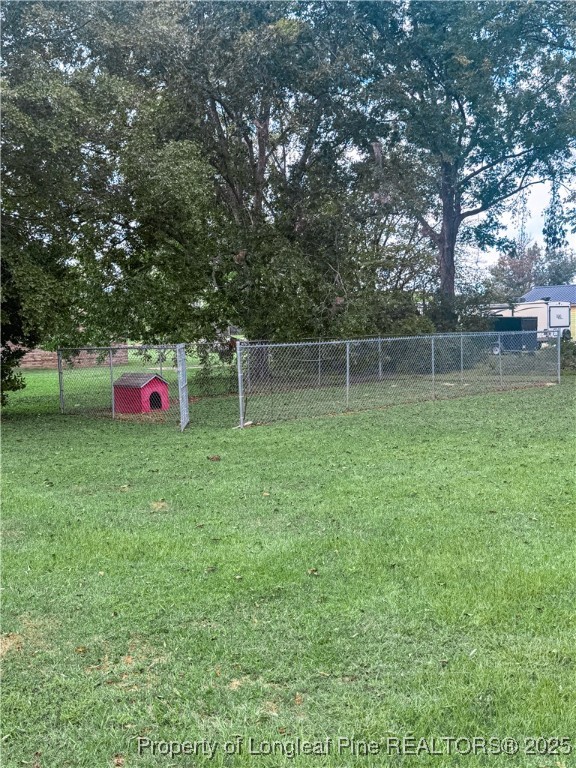 2879 County Line Road St. Pauls, NC 28384 - Photo 24 of 24 a backyard of a house with lots of green space and plants
