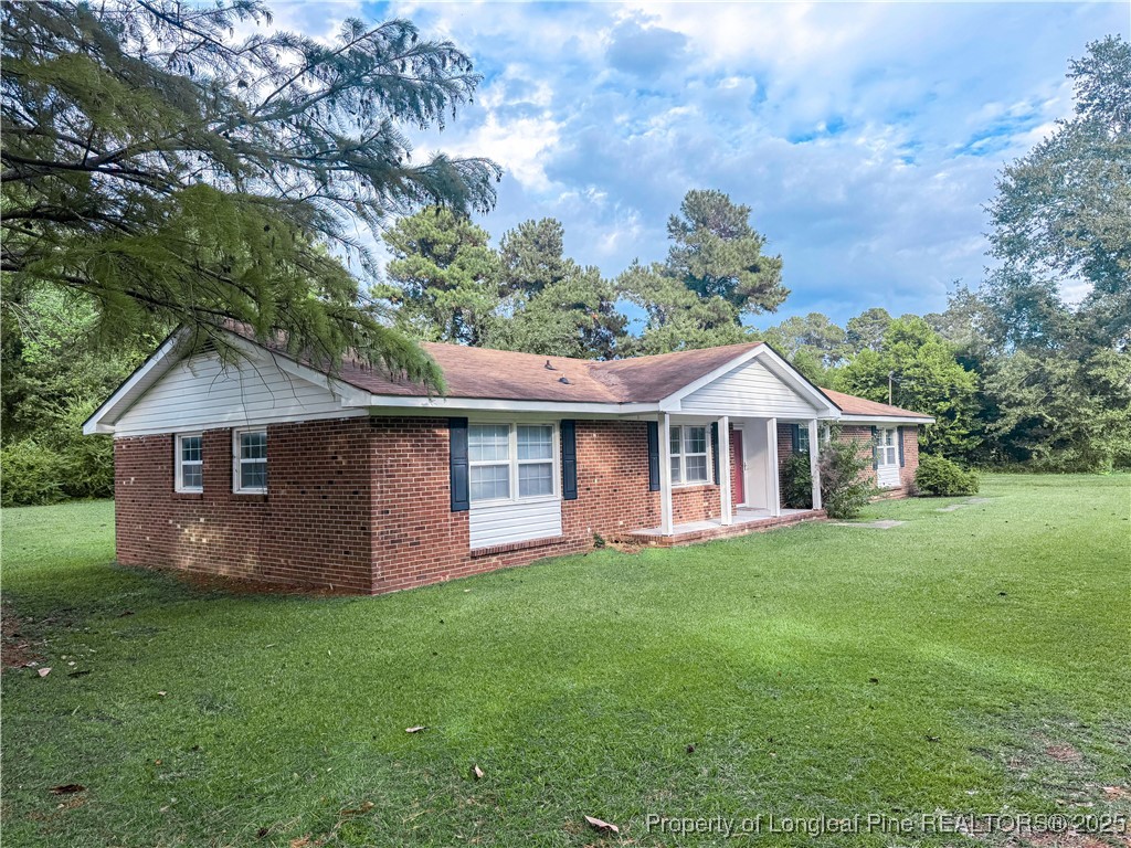2879 County Line Road St. Pauls, NC 28384 - Photo 3 of 24 a front view of a house with a garden