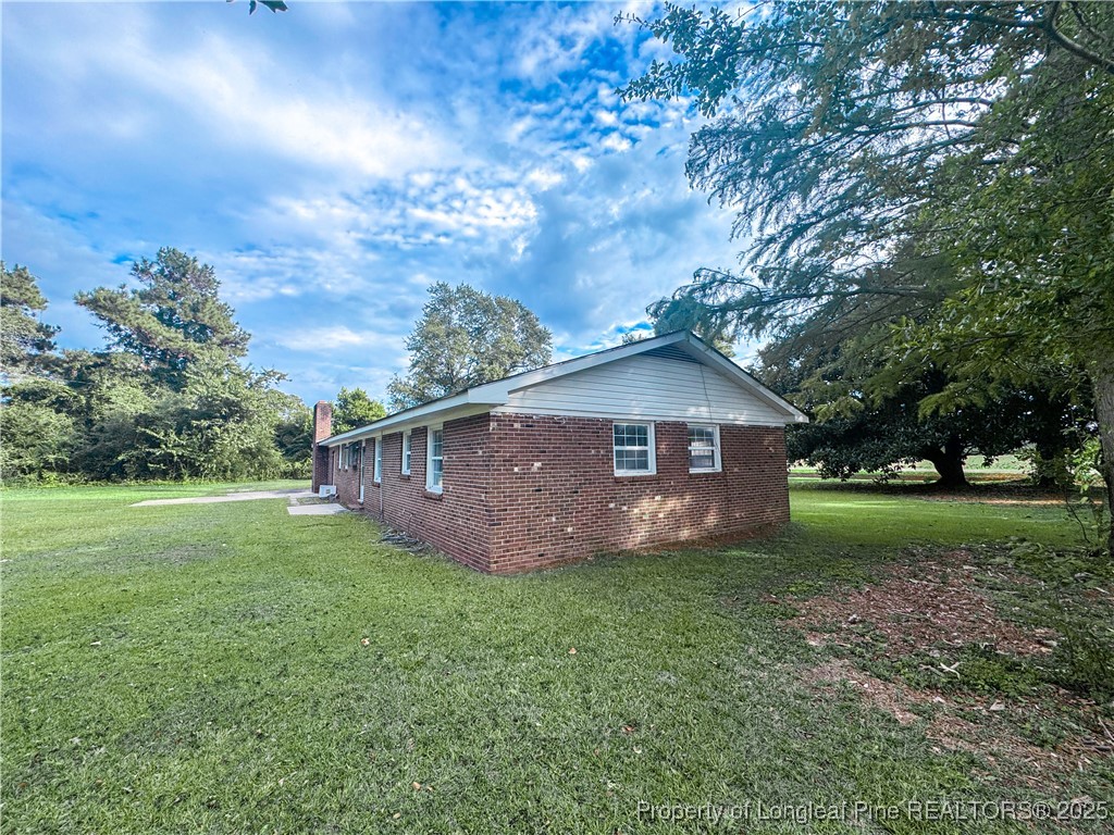 2879 County Line Road St. Pauls, NC 28384 - Photo 4 of 24 a view of house with yard and trees in the background