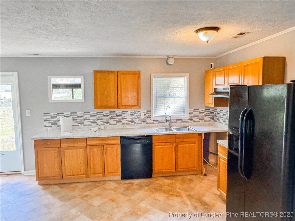 2879 County Line Road St. Pauls, NC 28384 - Photo 7 of 24 a kitchen with stainless steel appliances granite countertop a refrigerator and a sink