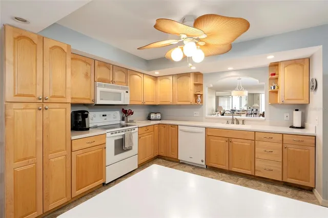 a spacious bedroom with a bed and a lamp