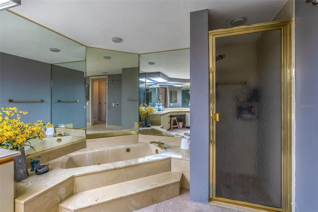 6500 Sunset Way, Unit 116 St. Pete Beach, FL 33706 - Photo 19 of 56 a bathroom with a tub shower and sink