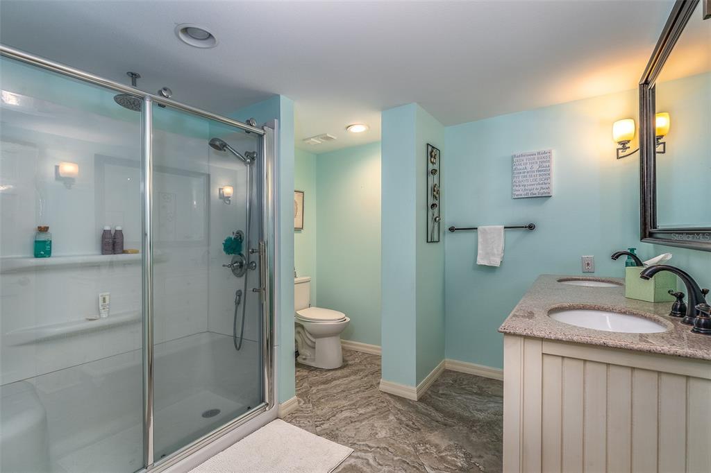 6500 Sunset Way, Unit 116 St. Pete Beach, FL 33706 - Photo 22 of 56 a bathroom with a sink a toilet and shower