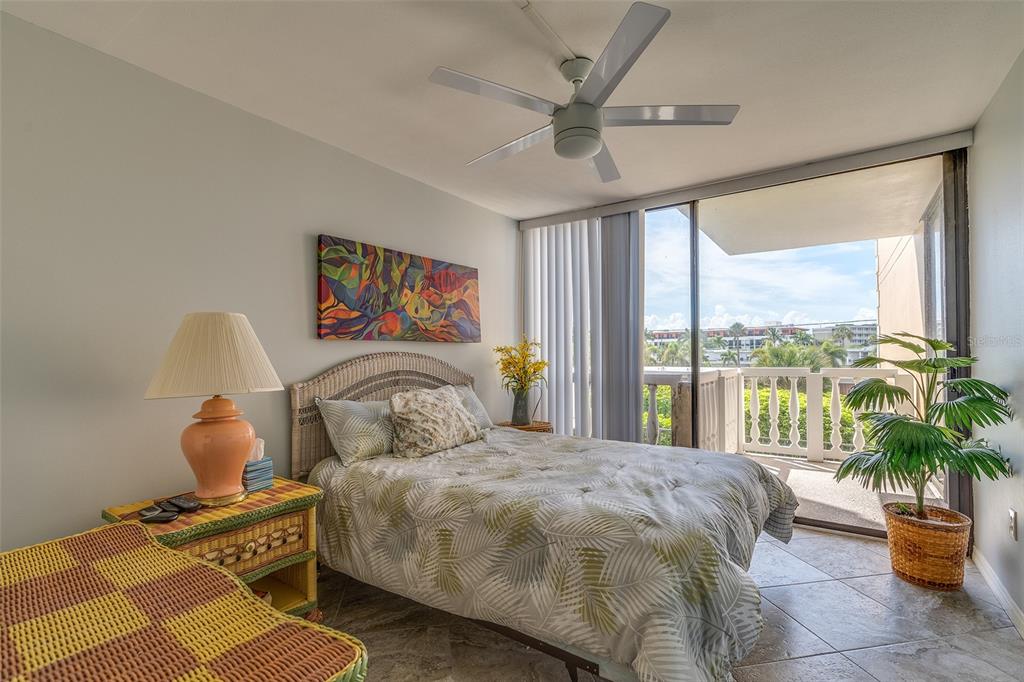 6500 Sunset Way, Unit 116 St. Pete Beach, FL 33706 - Photo 24 of 56 a bedroom with a bed and a large window