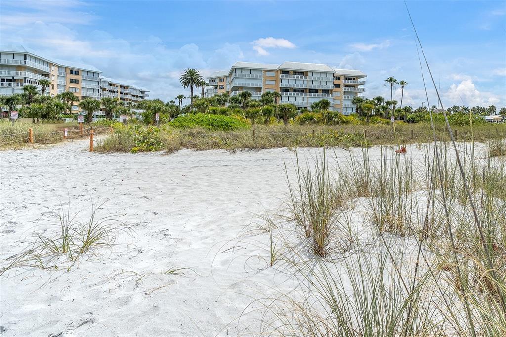 6500 Sunset Way, Unit 116 St. Pete Beach, FL 33706 - Photo 34 of 56 a view of a lake with a building in the background