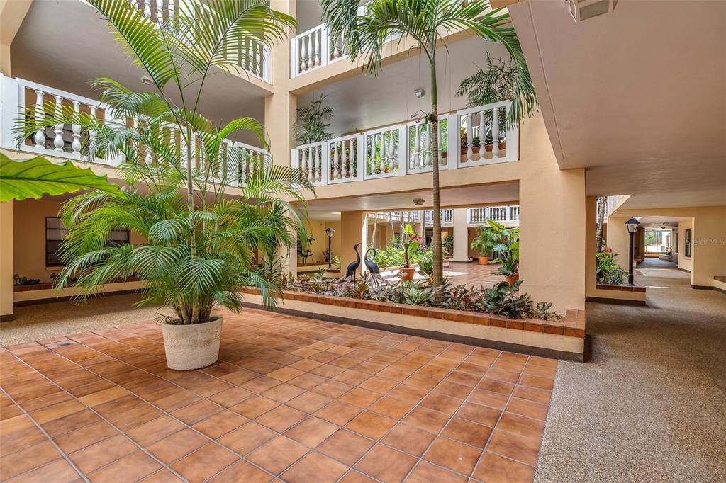 6500 Sunset Way, Unit 116 St. Pete Beach, FL 33706 - Photo 36 of 56 a view of a building with sitting area