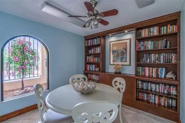 a view of a a dining room with furniture window and wooden floor