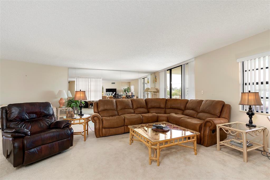 6500 Sunset Way, Unit 116 St. Pete Beach, FL 33706 - Photo 4 of 56 a living room with furniture and a window