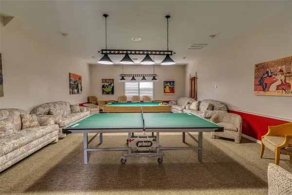 a view of a fountain in front of a brick house