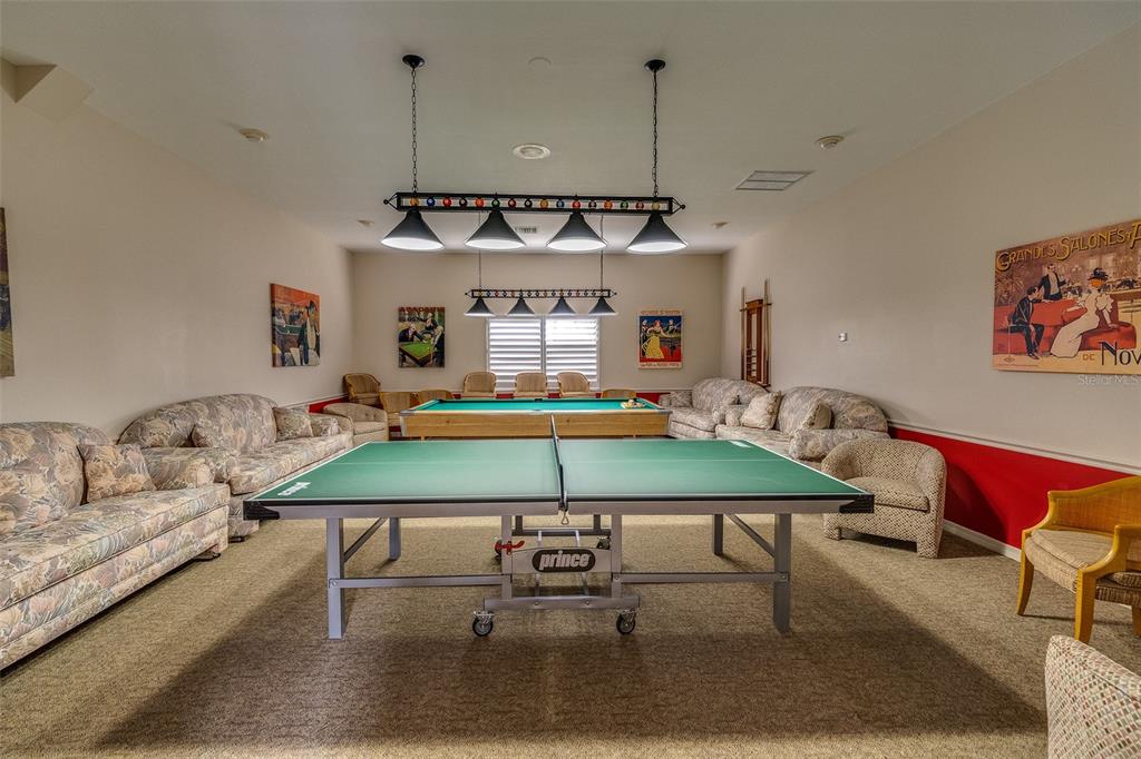 6500 Sunset Way, Unit 116 St. Pete Beach, FL 33706 - Photo 50 of 56 a living room with furniture and wooden floor