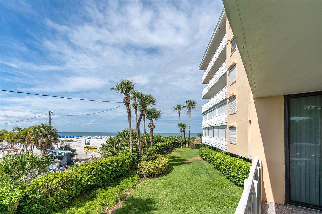 6500 Sunset Way, Unit 116 St. Pete Beach, FL 33706 - Photo 9 of 56 a view of yard from a corridor