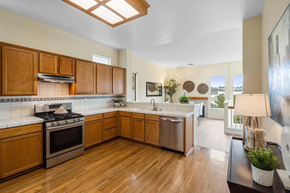 586 Alexis Circle Daly City, CA 94014 - Photo 16 of 61 a kitchen with a sink stove and wooden floor