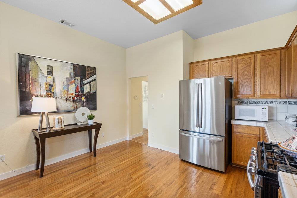 586 Alexis Circle Daly City, CA 94014 - Photo 18 of 61 a view of a kitchen with furniture wooden floor electronic appliances and windows