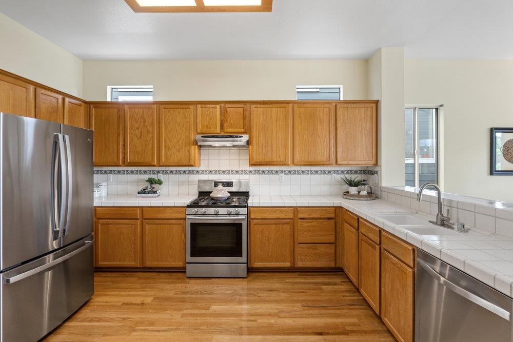 586 Alexis Circle Daly City, CA 94014 - Photo 19 of 61 a kitchen with stainless steel appliances granite countertop a sink stove and refrigerator