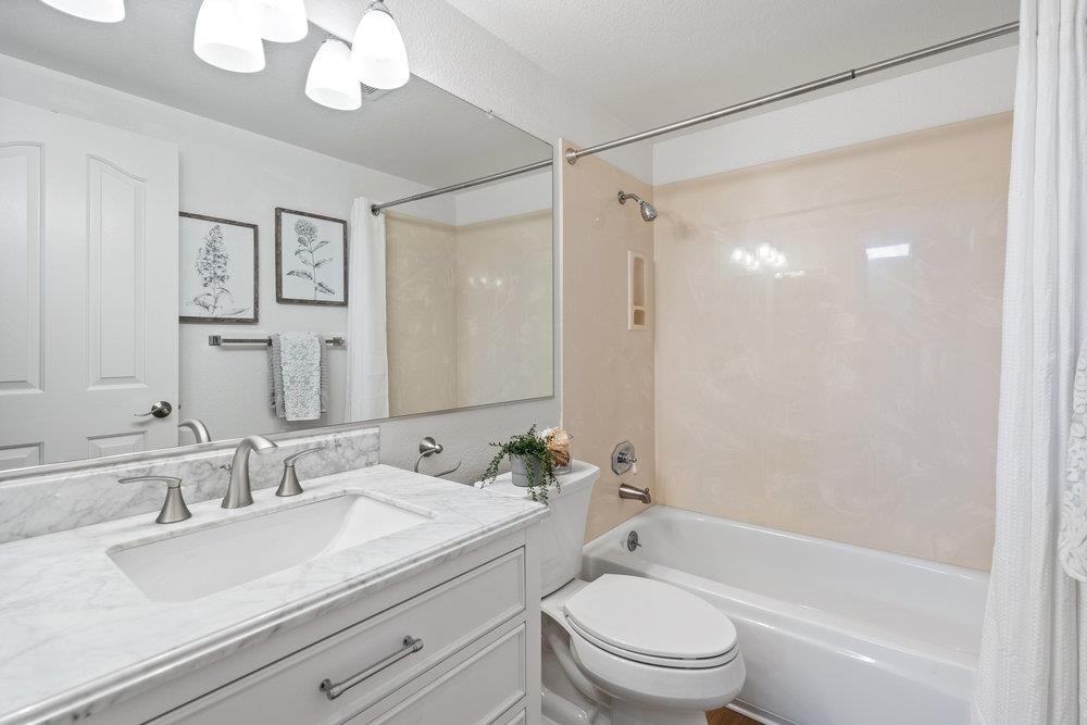 586 Alexis Circle Daly City, CA 94014 - Photo 36 of 61 a bathroom with a granite countertop sink a toilet and shower